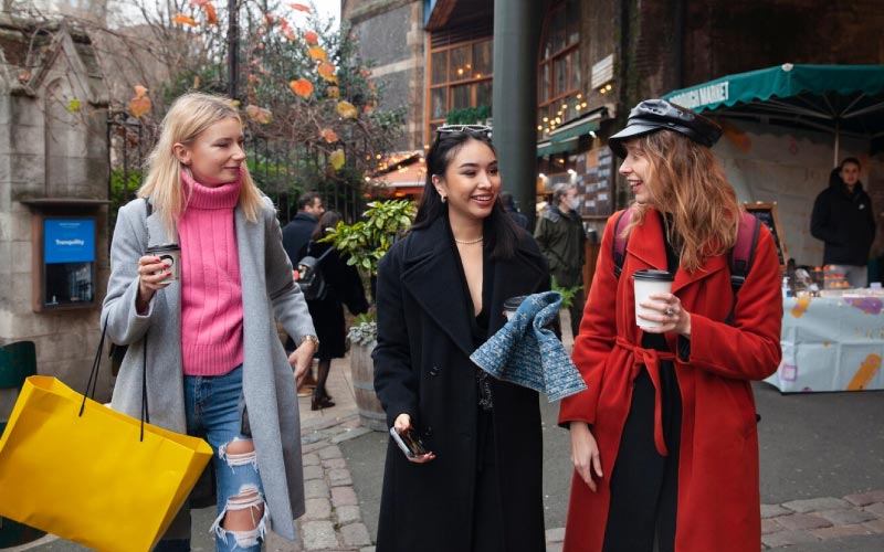 girls walking together outside boutiques, event trips, July 2024, UK