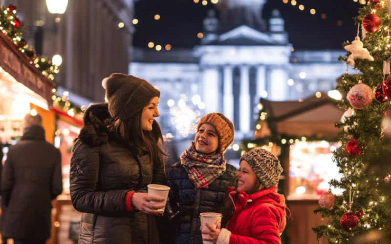 excited children chatting on an Xmas decorated street, London, October 2024