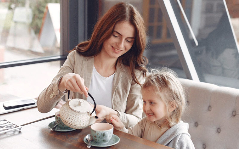 a young family enjoying afternoon tea, family trip, August 2024, UK